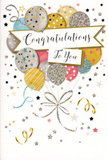 The scene shows a stylish congratulations card, its front bursting with the quiet excitement of a well-earned celebration in Ilford. The central illustration is a cluster of balloons, gathered as if in a bouquet and gently floating upward. Their colours form a soft, harmonious palette: muted gold, brushed silver, champagne, powder blue, blush pink, and cool grey. Each balloon is shaped with subtle shading so it appears round and lightly reflective, as though it might sway if touched. Decorative accents-tiny metallic stars, slim stripes, and areas of fine glitter-catch the imaginary light, recalling the twinkling reflections you might notice in shopfronts along the Exchange. Slender gold and silver ribbons fall from the bunch in graceful curls, adding a sense of motion, like streamers trailing from a celebration near Valentines Park. Across the heart of the balloon bouquet, a broad banner sweeps from side to side, bearing the words Congratulations To You in flowing script that feels personal and sincere. Surrounding this focal point, the background remains soft and neutral, dotted with little stars, confetti-like specks, and curving flourishes in metallic ink. These details give the impression of a sky filled with scattered stardust just after someone has been showered with applause. Subtle foiling along the edges of the balloons and stars adds a gentle shimmer, offering a hint of texture you can almost imagine beneath your fingertips. The overall mood is refined, festive, and heartfelt, making the card a perfect companion to a bouquet delivered across Ilford for graduations, new jobs, promotions, or any cherished milestone where words and flowers together help express genuine pride and happiness.